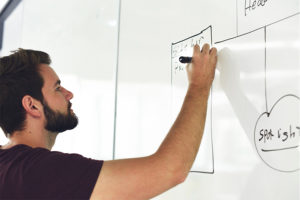 screenshot of a guy drawing on a board